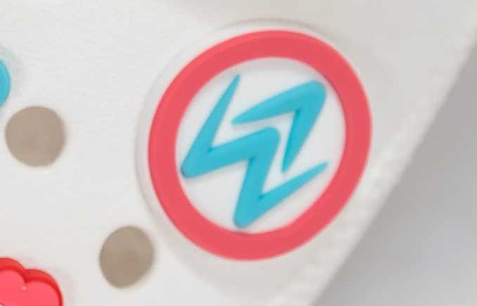 Colorful logo with a blue zigzag design inside a red circle on a white background