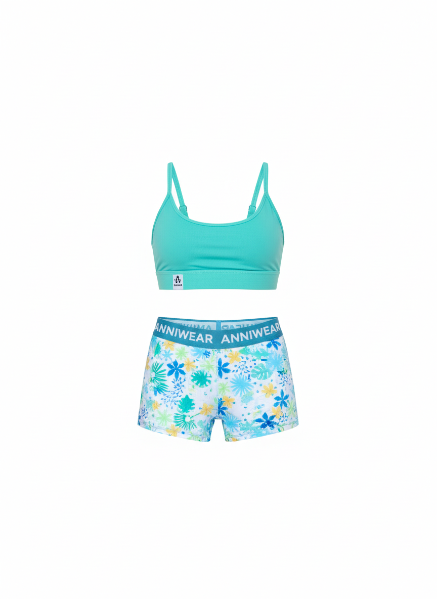 Turquoise sports bra and floral shorts set on a white background