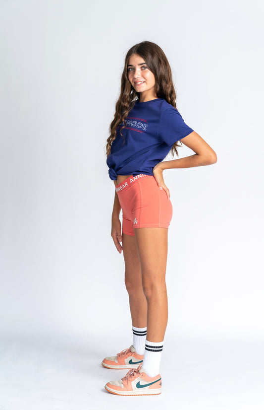 Person wearing a blue 'Beast Mode' t-shirt with visible branding on a white background