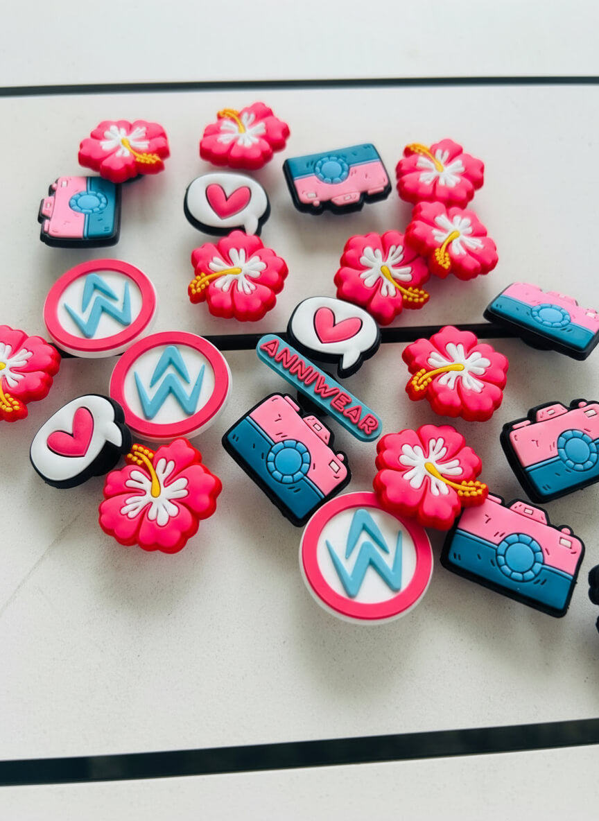 Collection of colorful rubber shoe charms with various designs on a white surface