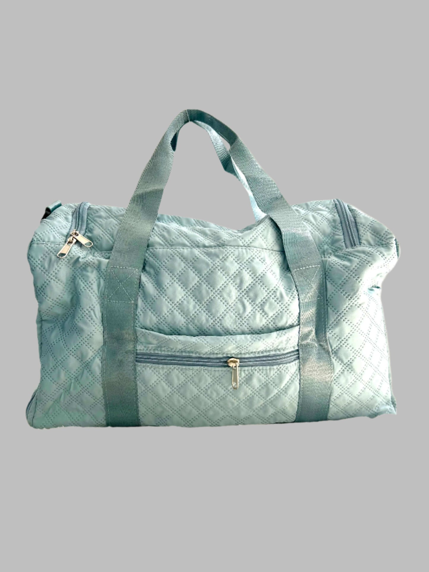 Light blue checkered duffel bag on a beige background