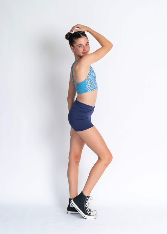 Blue floral sports bra and navy high waisted shorts on a person