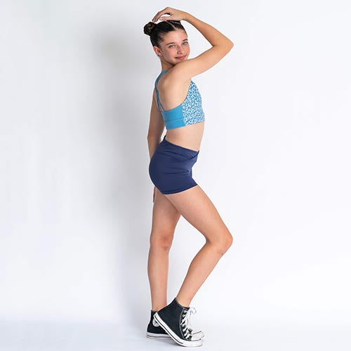 Blue floral sports bra and navy high waisted shorts on a person