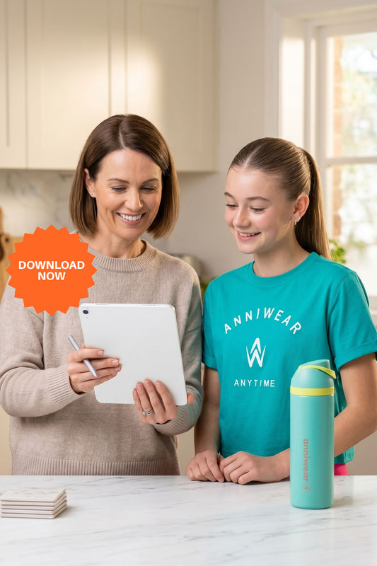 Woman and young girl looking at a tablet in a kitchen with a water bottle on the counter.
