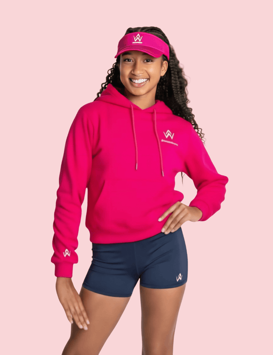 Woman wearing a pink hoodie and visor with a logo on a pink background