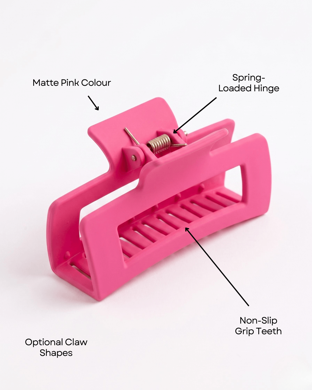 Pink hair clip with labeled features on a white background