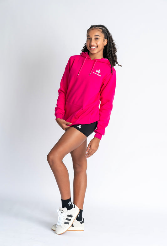 Person wearing a bright pink hoodie with a logo on a light gray background