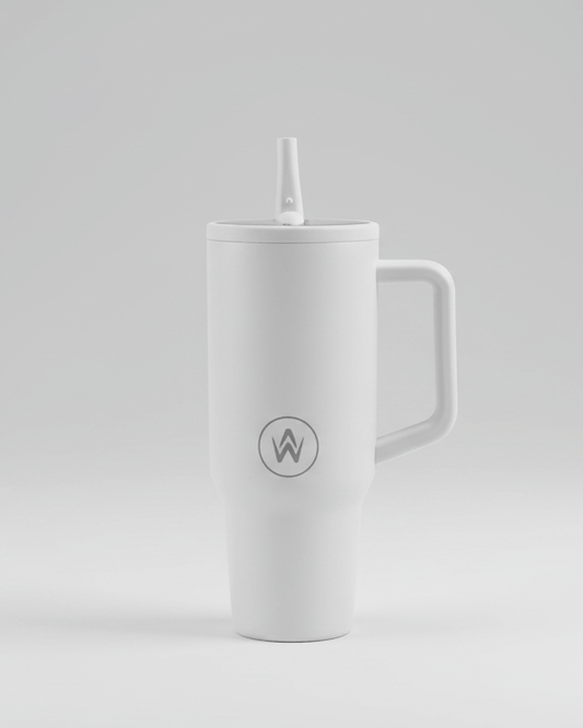 White tumbler with handle and straw on a light gray background