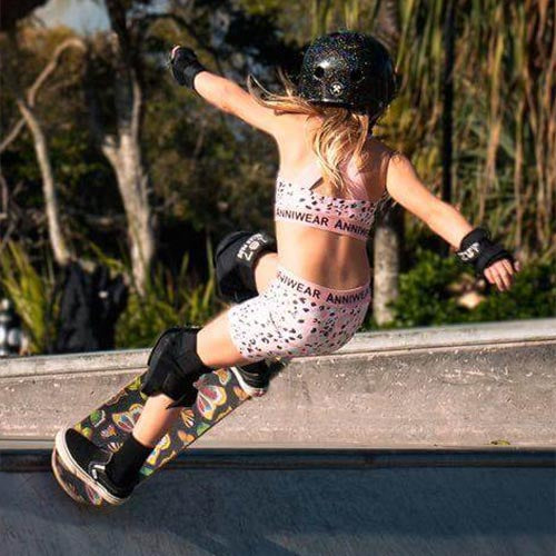 Person skateboarding on a concrete ramp with another person in the background.