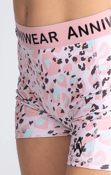 Pink patterned active shorts with 'Anniwear' branding on a white background