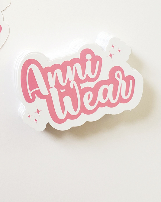 Sticker with 'Anni Wear' text on a white background