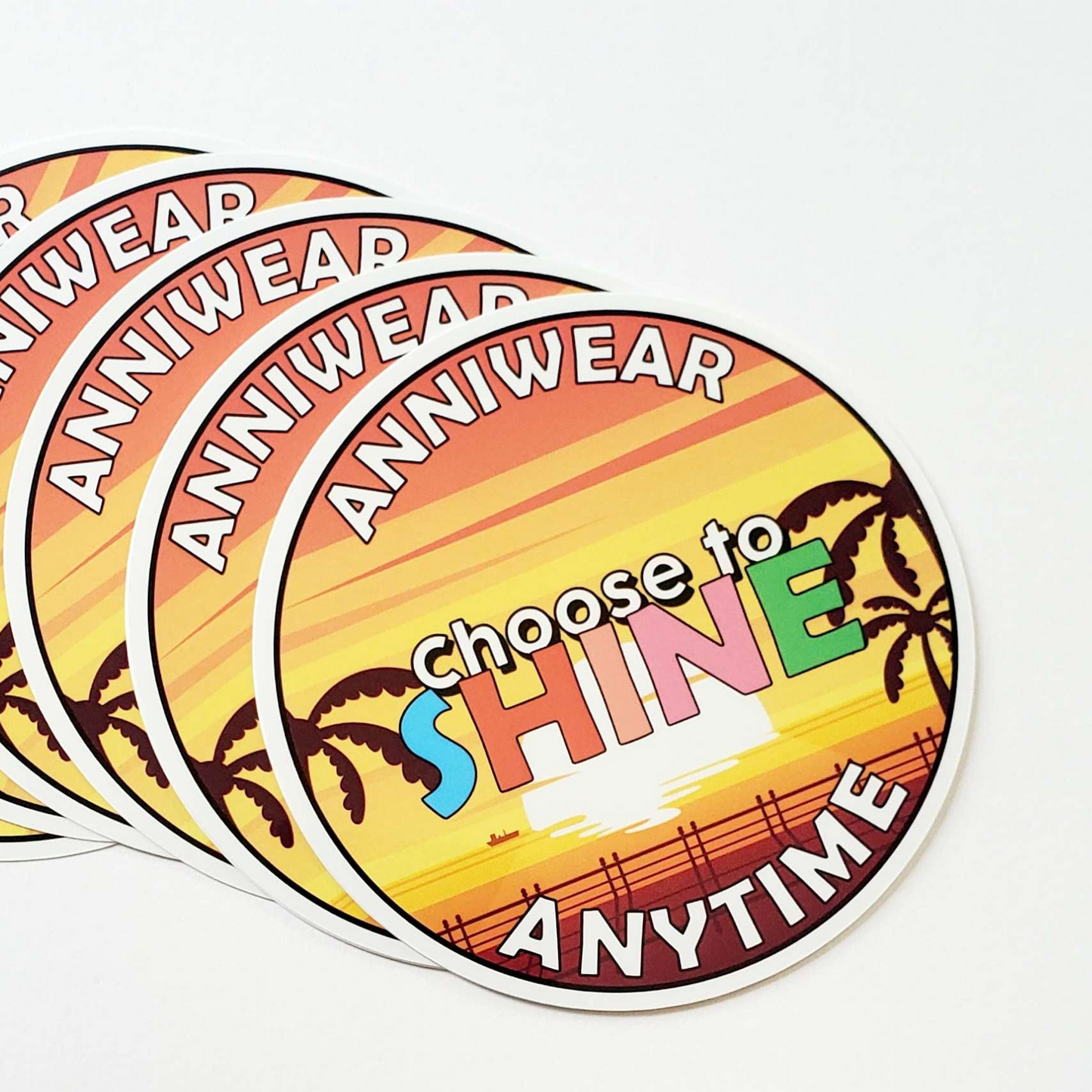 Colorful sticker with 'choose to SHINE ANYTIME' text and palm tree design on a white background