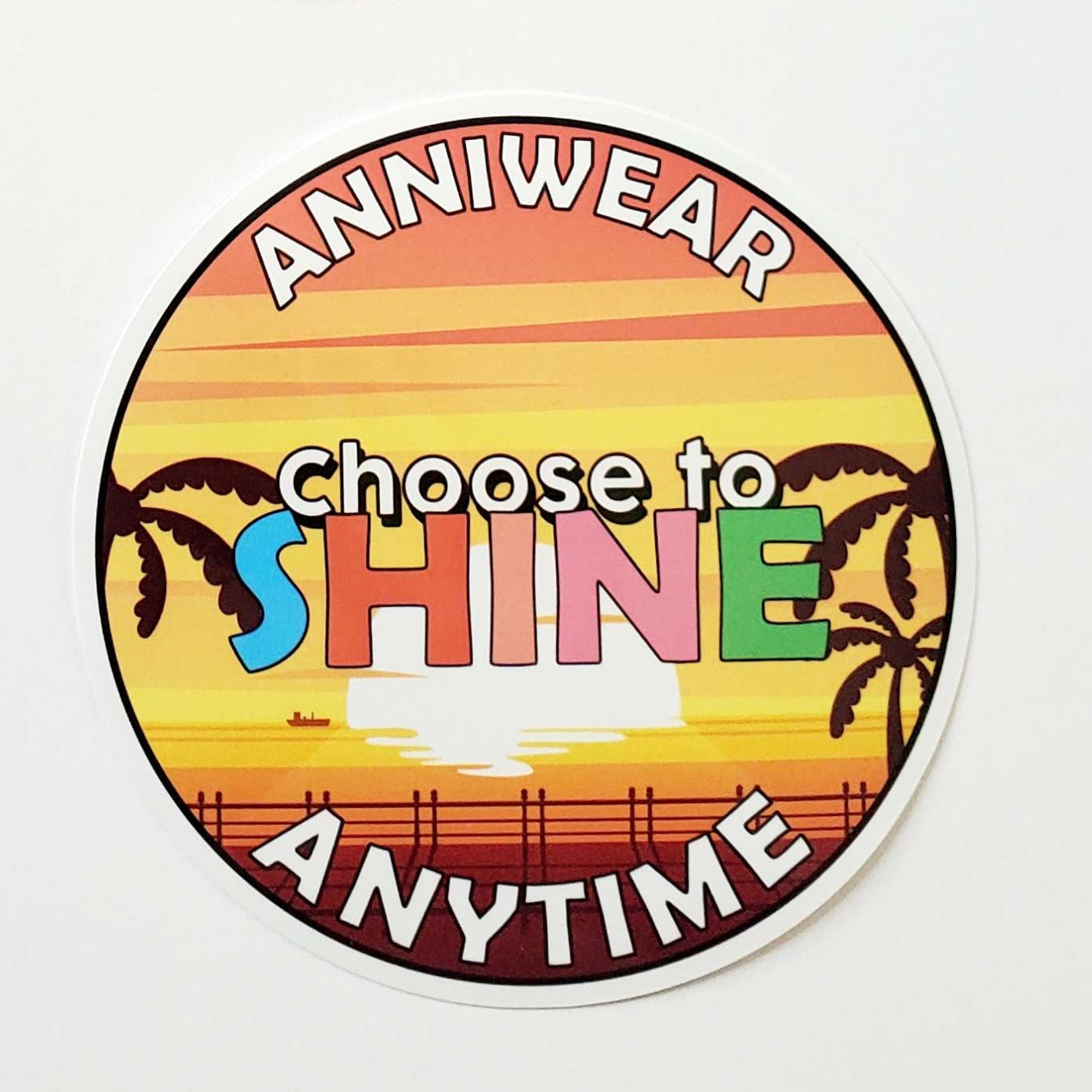 Circular sticker with sunset design and text 'Choose to Shine Anytime' on a white background