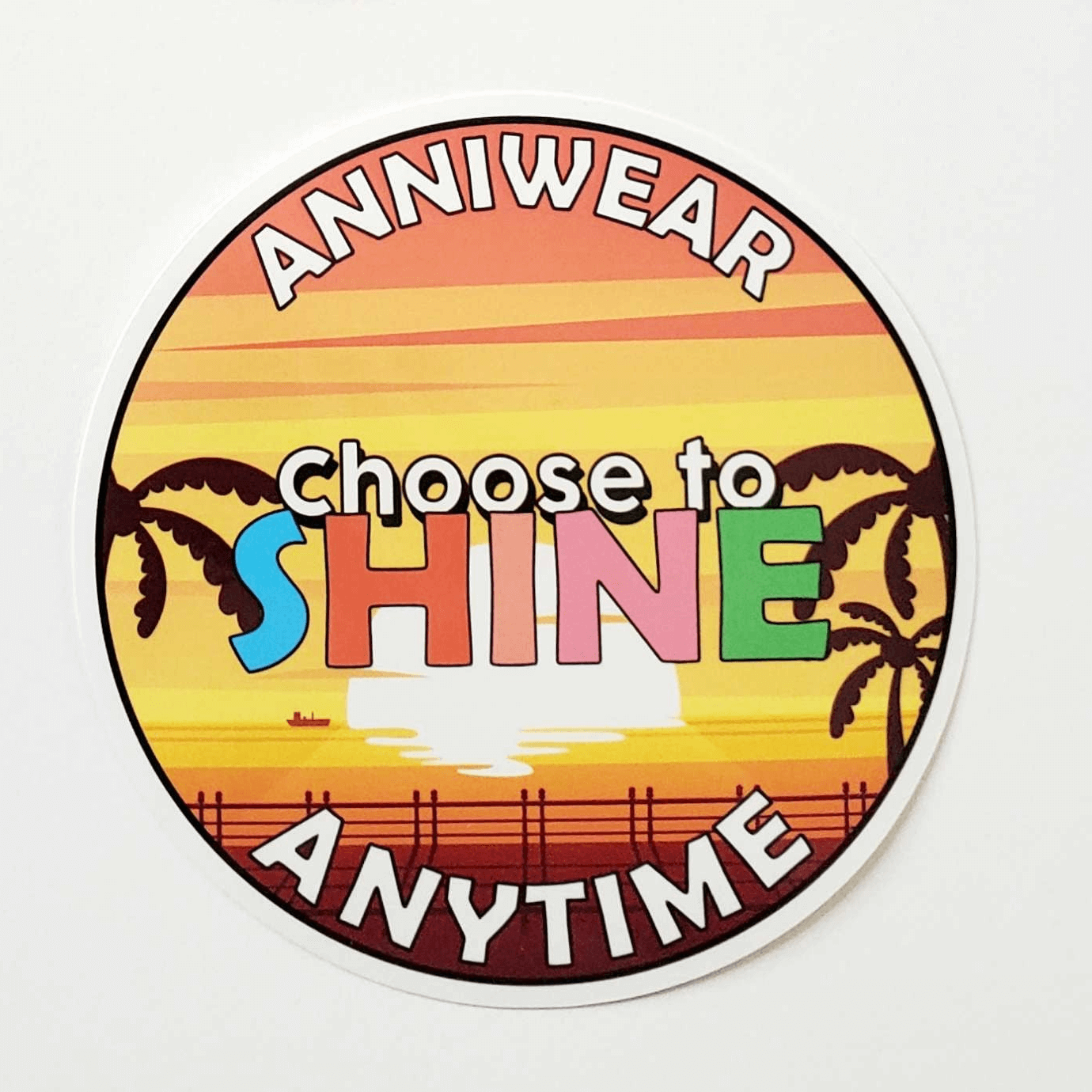 Circular sticker with sunset design and text 'Choose to Shine Anytime' on a white background