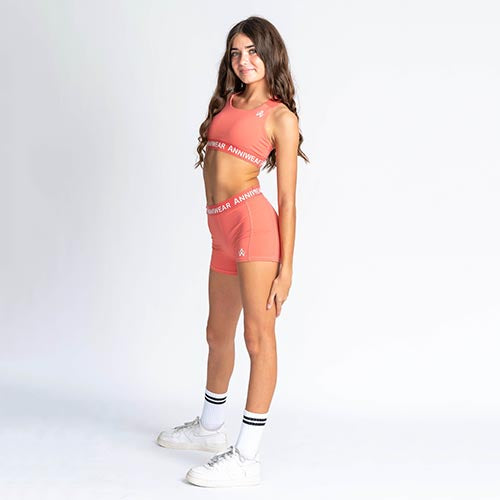 Coral athletic crop and shorts with 'ANNIWEAR' branding on a white background