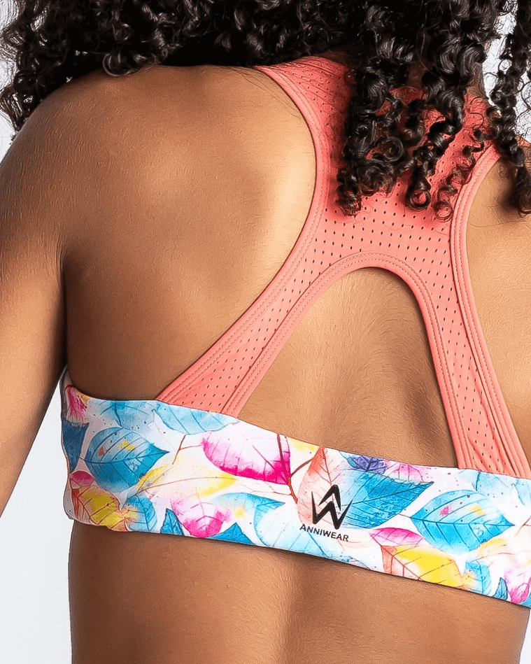 Coral and Tropical Leaf print sports bra on a white background