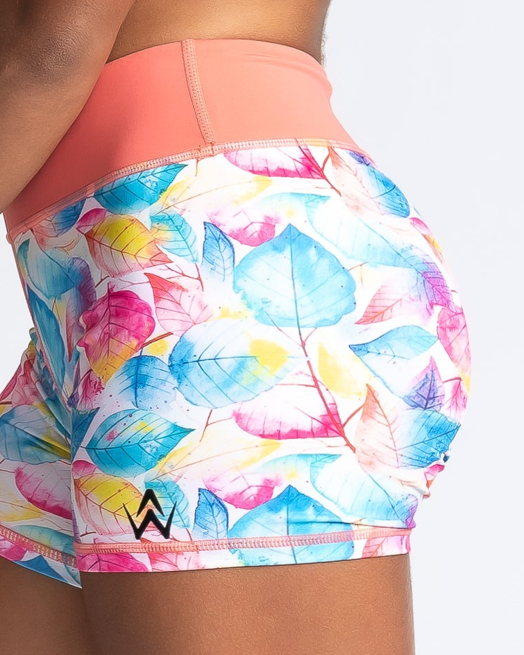 Colorful leaf-patterned shorts with a brand logo on a white background