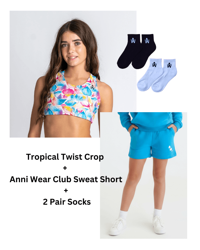 Teen girl wearing a tropical twist crop top with matching shorts and socks on a white background