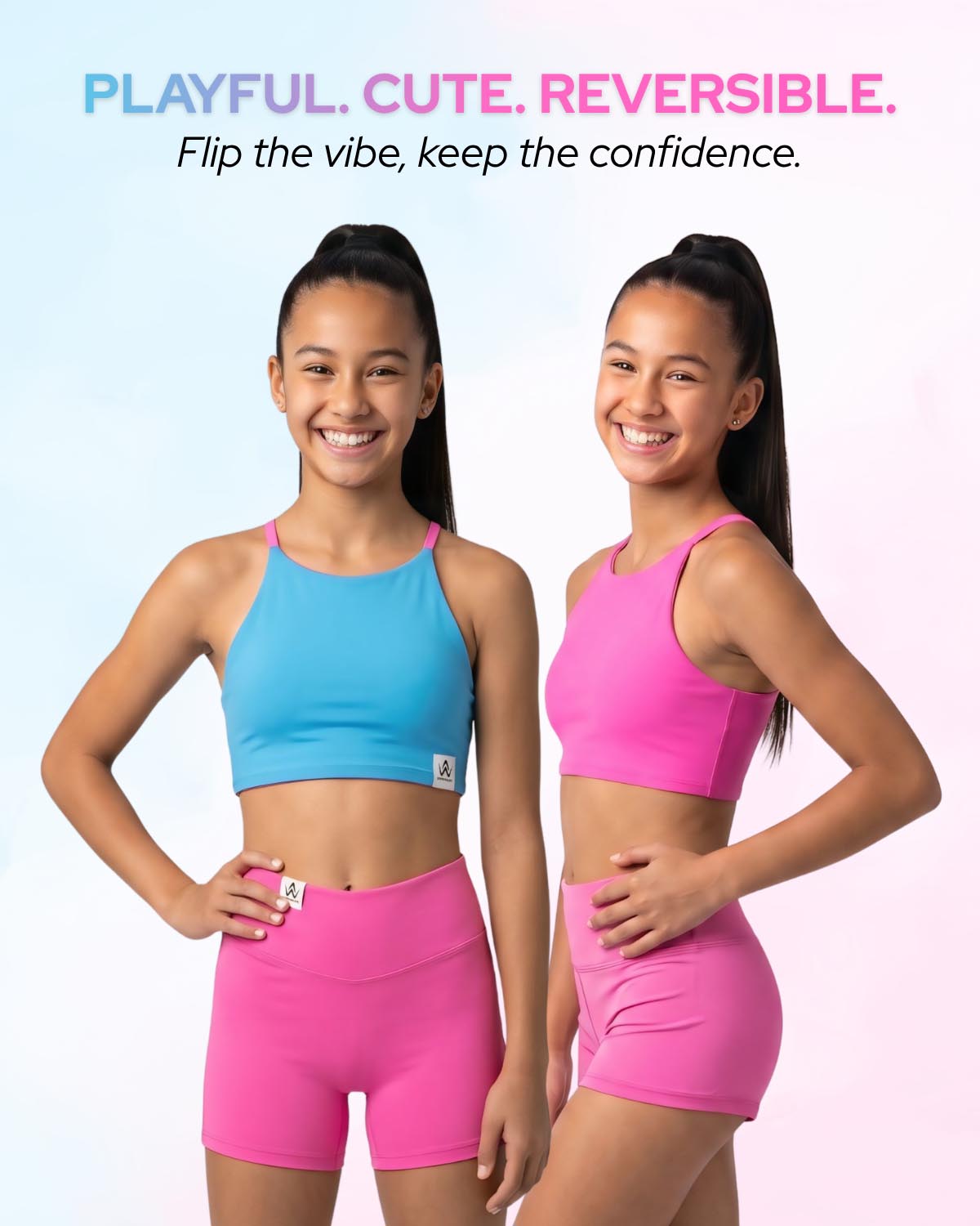 Two young girls modeling matching athletic wear, one in a light blue crop top and hot pink shorts, and the other in a hot pink crop top and matching pink shorts. They are standing against a light pastel gradient background with the text 'PLAYFUL.
