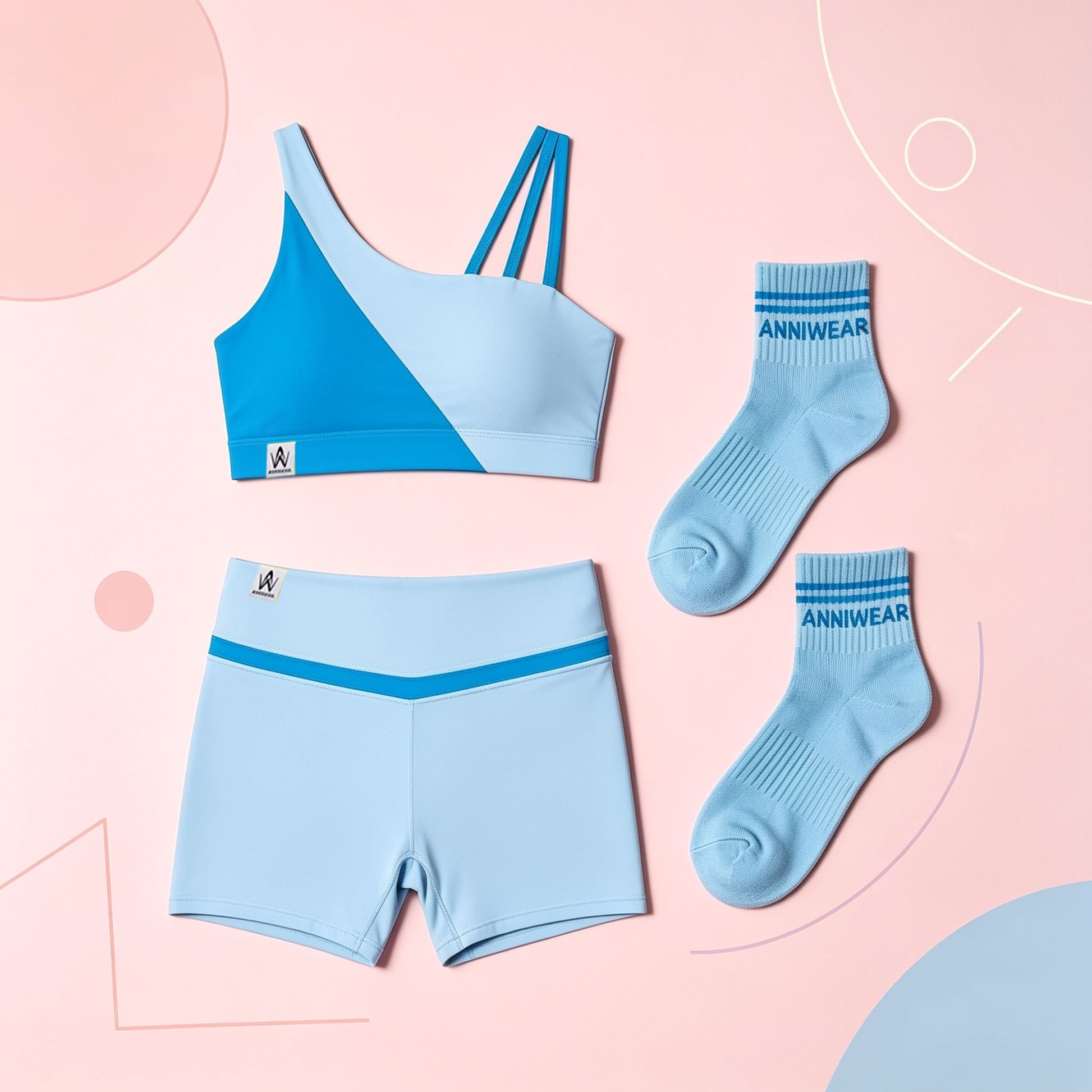 Light blue sports bra, shorts, and socks with 'ANNIWEAR' branding on a pink background