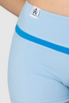 Light blue athletic shorts with a brand logo on a white background