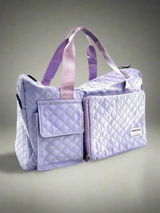 Purple quilted bag with a visible brand label on a gray background