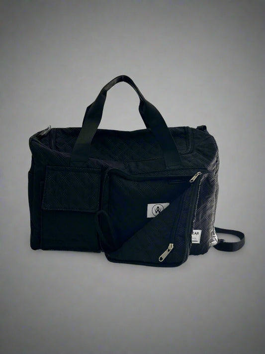 Black bag with multiple compartments on a gray background