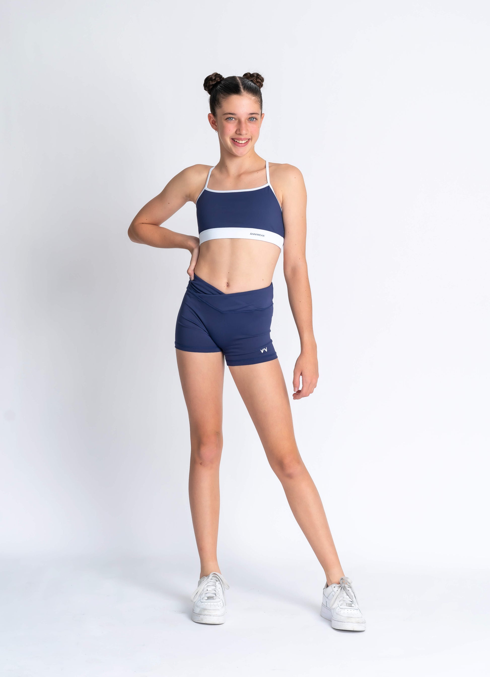Navy blue sports bra with white accents and 'Anniwear' branding on a plain background