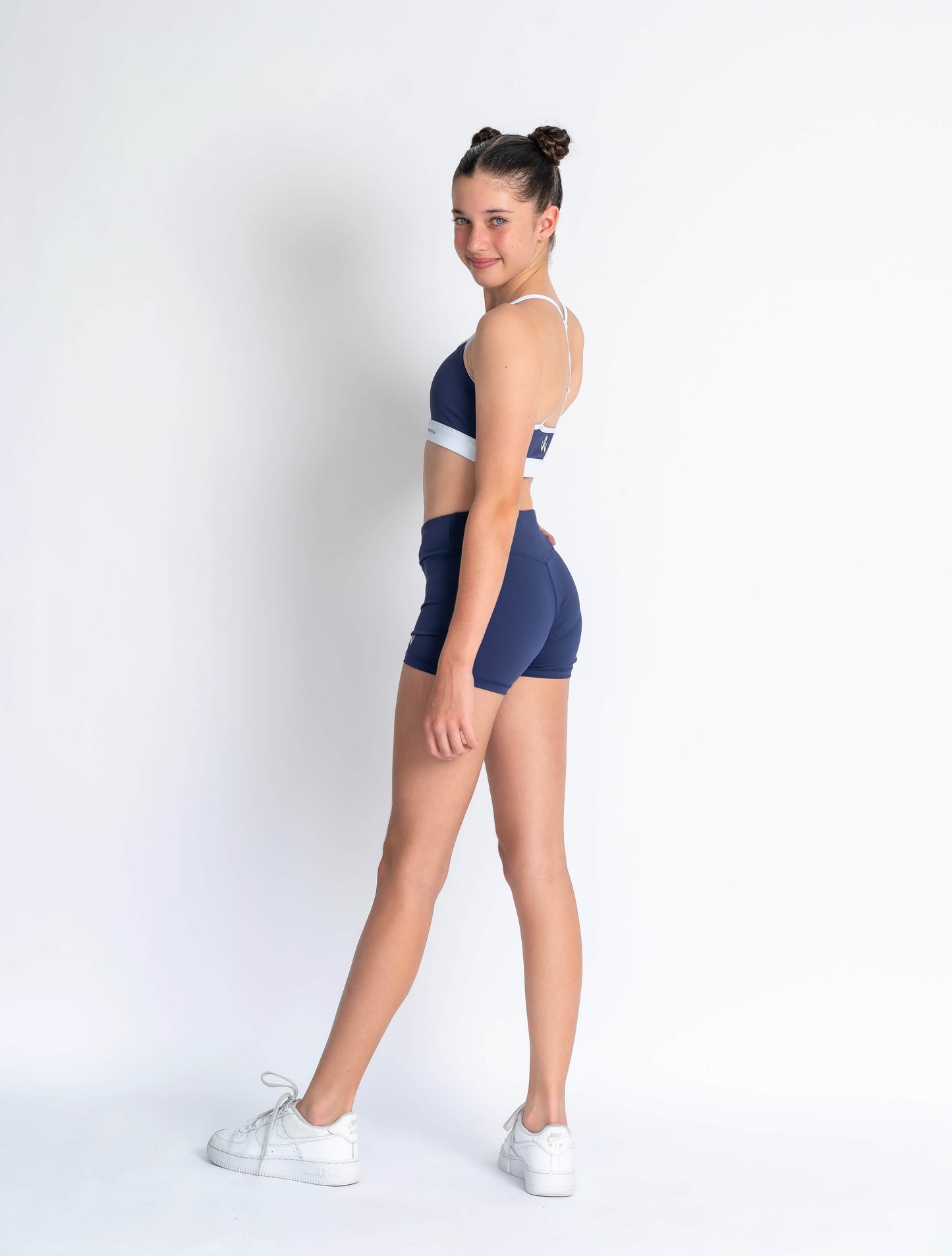 Navy blue sports bra with white accents and 'Anniwear' branding on a plain background