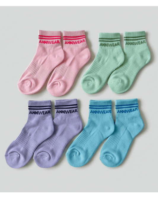 Set of colorful socks with 'ANNIWEAR' branding on a light gray background