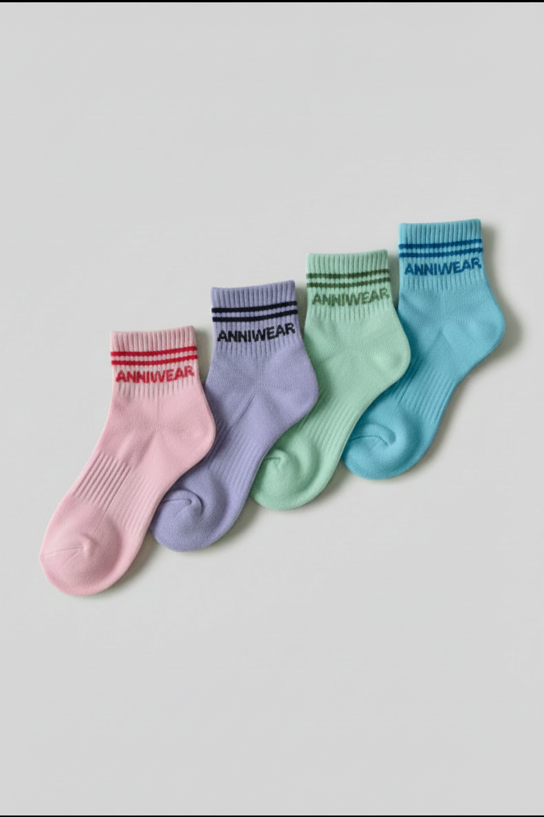 Four colorful socks with 'ANNIWEAR' branding on a light gray background