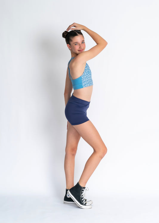 Blue floral sports bra and navy high waisted shorts on a person