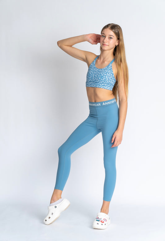 Blue floral sports bra on a person wearing blue leggings 
