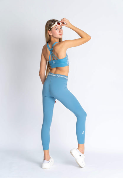 Blue floral sports bra on a person wearing blue leggings 