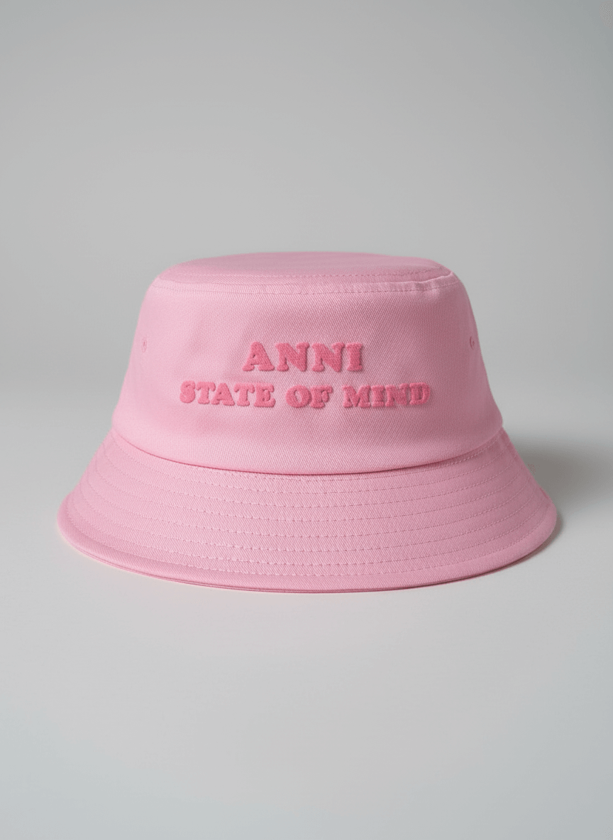 Pink bucket hat with 'ANNI STATE OF MIND' text on a gray background