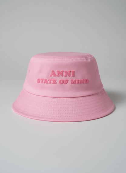 Pink bucket hat with 'ANNI STATE OF MIND' text on a gray background