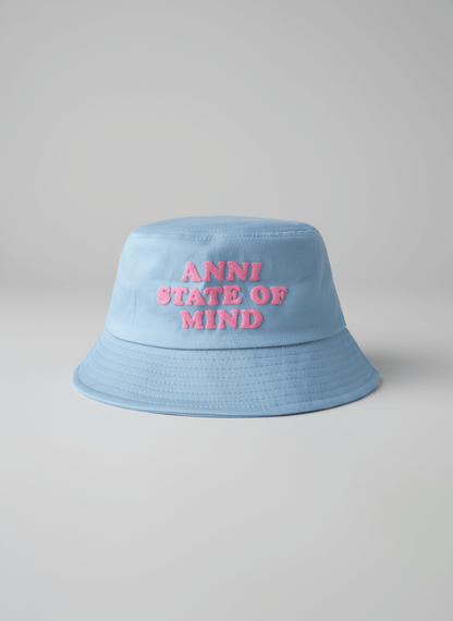 Light blue bucket hat with 'ANNI STATE OF MIND' text on a gray background