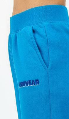 Blue sweatpants with 'ANNIWEAR' logo on a white background