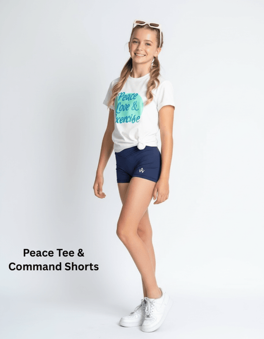 Girl wearing a white t-shirt with text and navy shorts on a white background