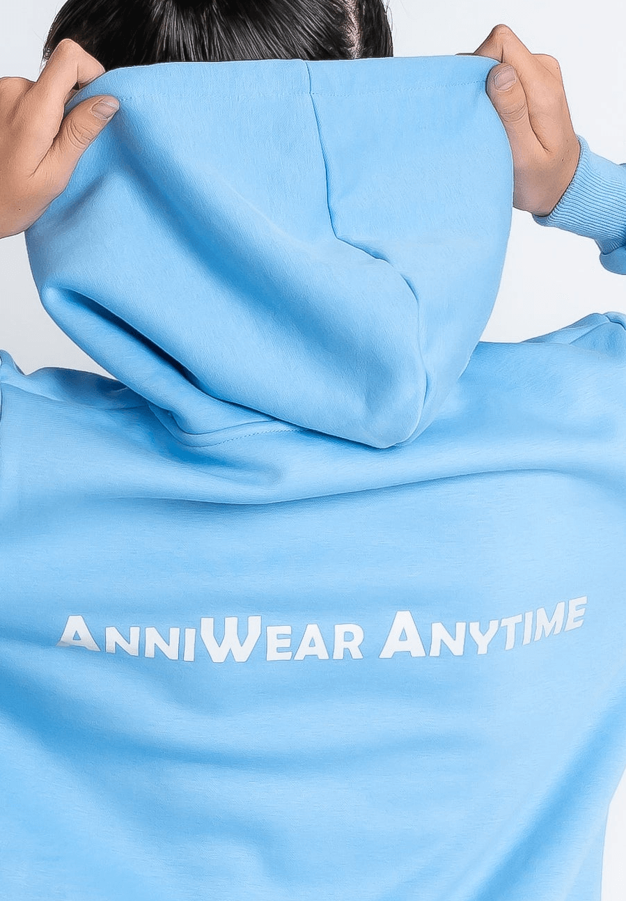 Person wearing a light blue hoodie with 'ANNIWEAR ANYTIME' text.