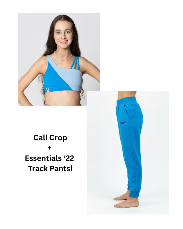 Woman wearing a blue sports bra and track pants with text 'Cali Crop + Essentials '22 Track Pants'.