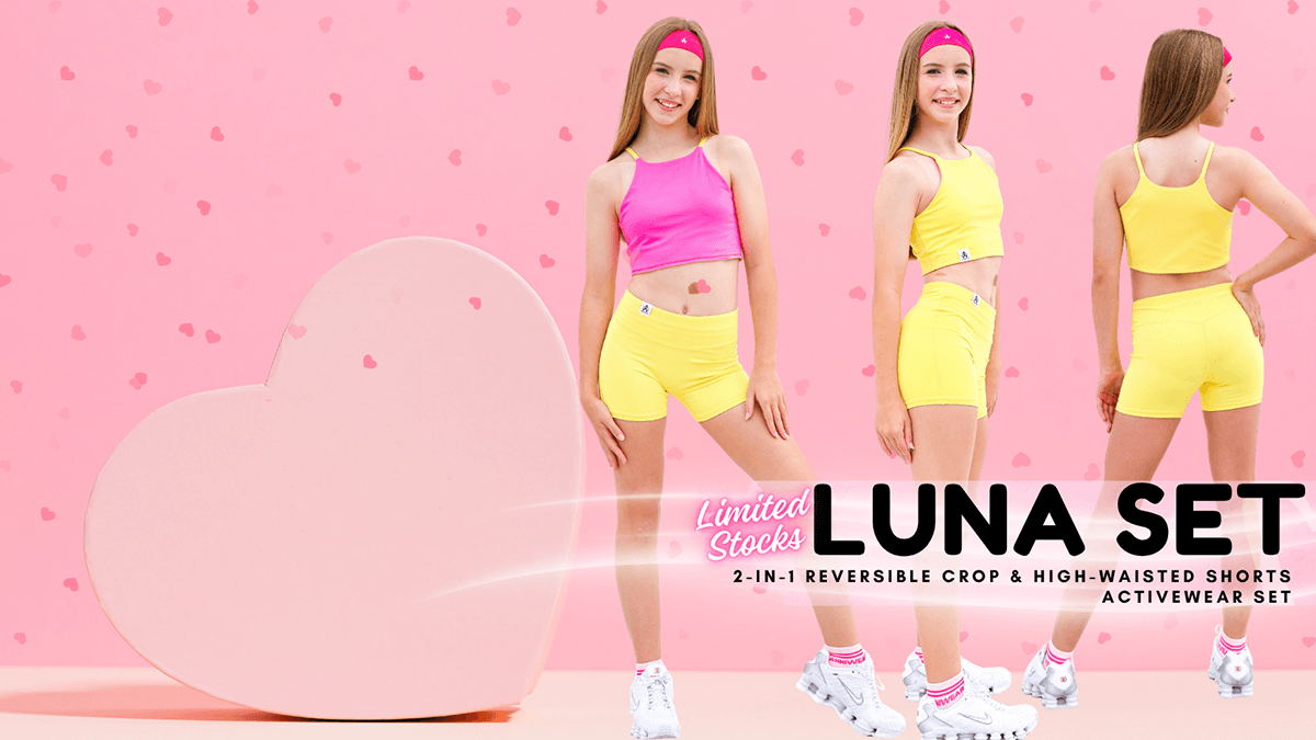 Two women modeling a reversible activewear set with pink and yellow colors on a pink heart-shaped background.