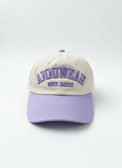 Beige and purple cap with 'ANNIWEAR EST. 2022' text on a white background