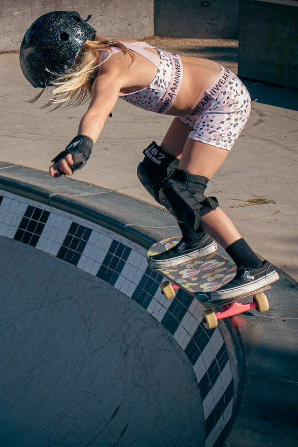 Person skateboarding on a ledge at a skate park