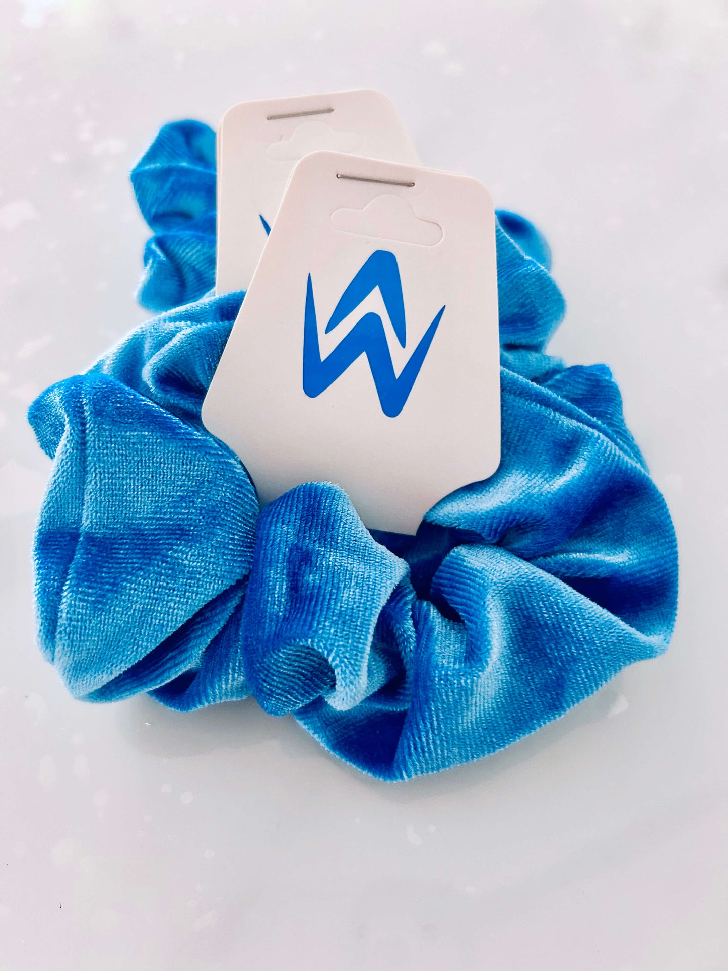 Blue velvet Scrunchie with logo on cardboard hang tag