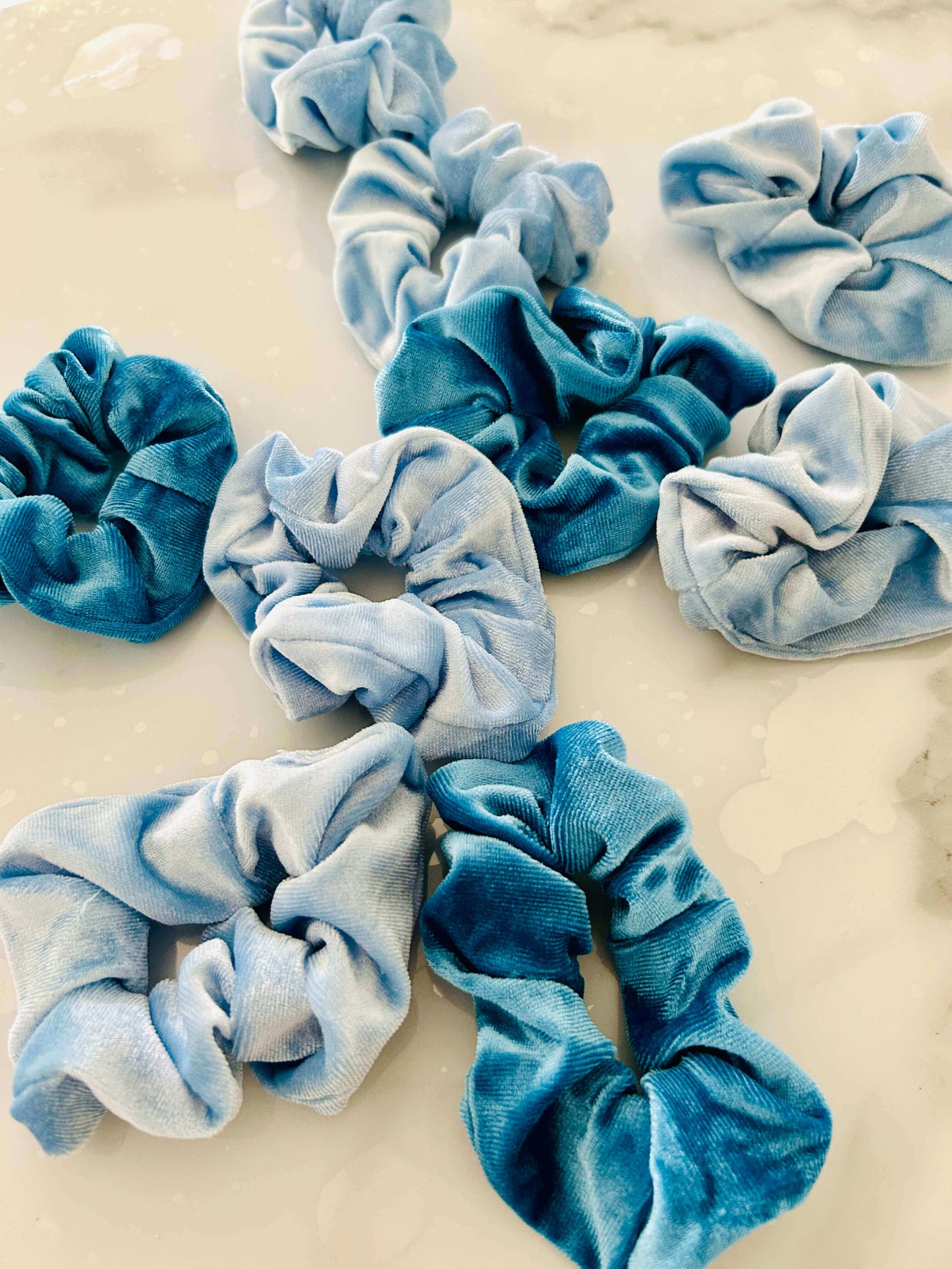 a mix of Blue Velvet scrunchies in Light blue and blue