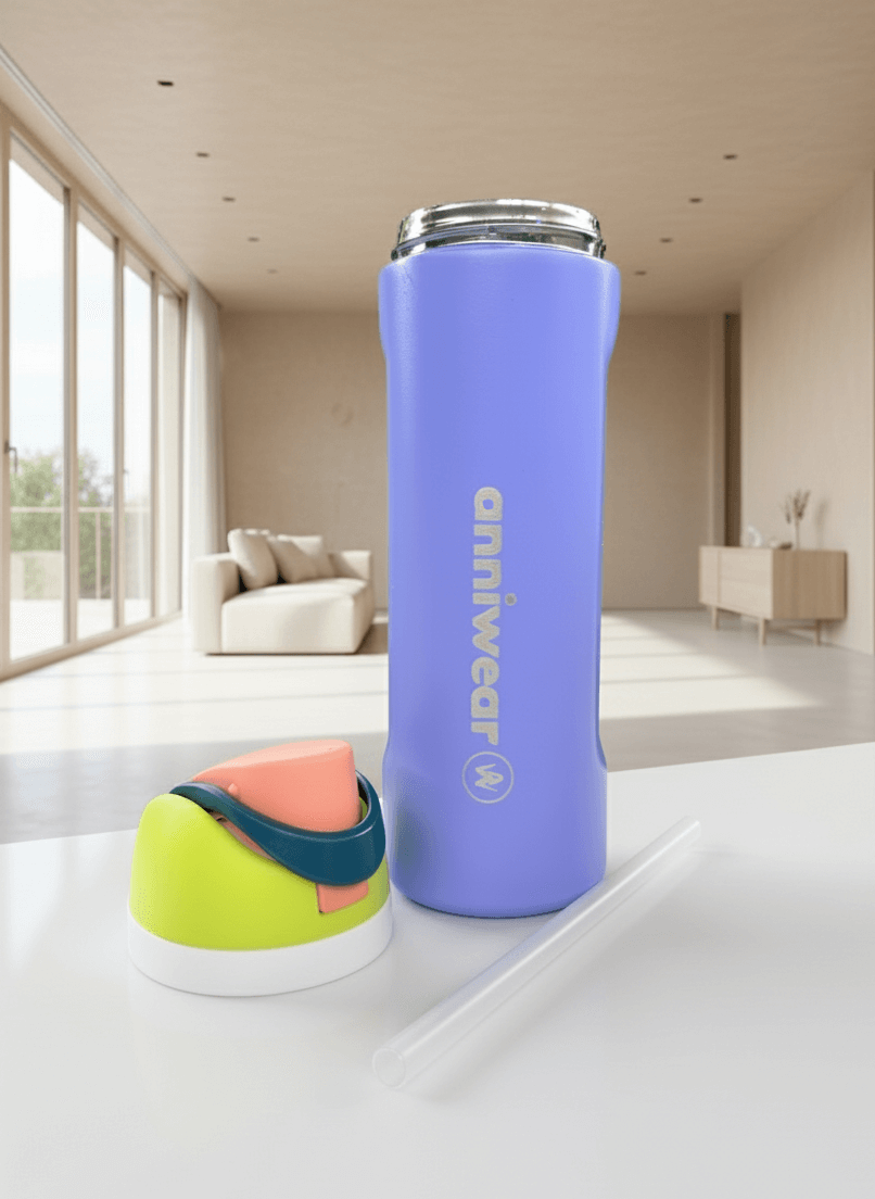 Purple tumbler with 'anniwear' branding on a white surface in a modern room.