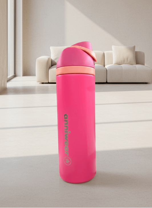 Pink water bottle with a brand logo on a light-colored floor.