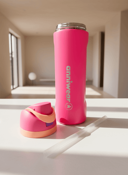 Pink water bottle with a smaller pink container on a reflective surface