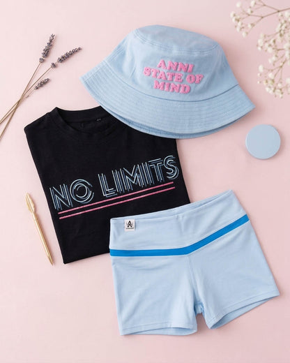 flat lay of a blue bucket hat, a black No Limits Tee and a pastel blue Shorts